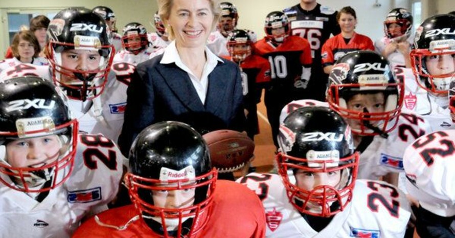 Die Bundesministerin für Arbeit und Soziales, Ursula von der Leyen bei den Spielern der Bambinigruppe des Footballvereins Düsseldorfer Panther, der Jugendlichen aus benachteiligten Familien eine vergünstigte Teilnahme am Training ermöglicht. Foto: picture-alliance